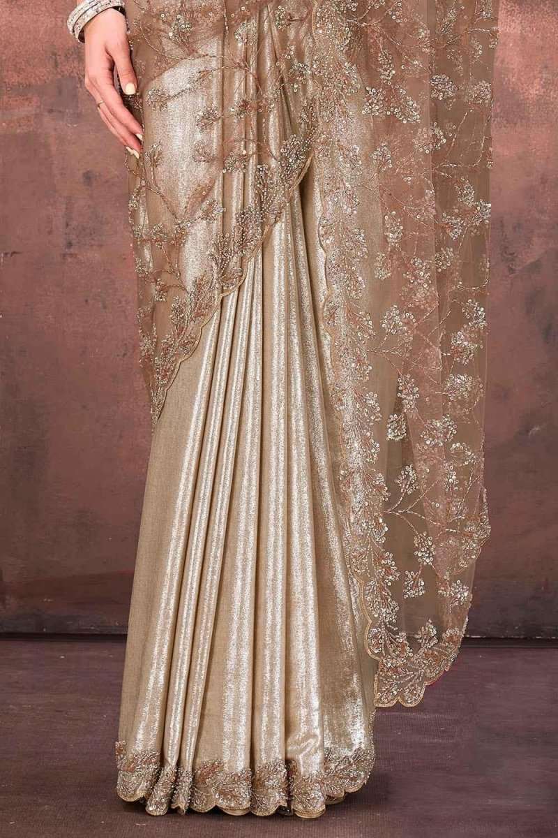 Champagne gold foil satin saree with pleated skirt and ornate embroidered hem