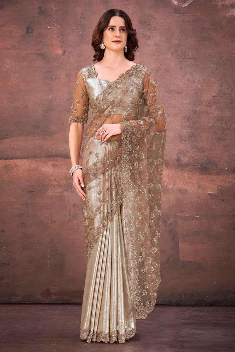 Champagne gold foil satin saree with ornate lace-like border and draped pallu
