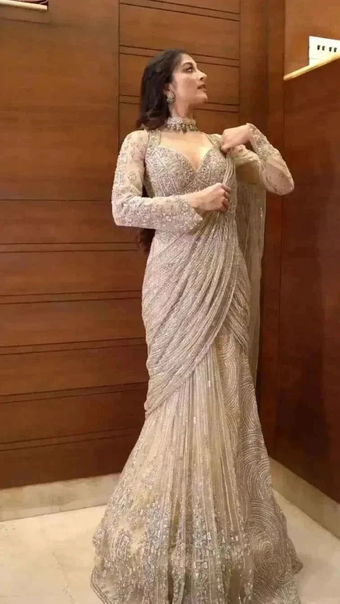 Champagne net saree with all-over sequin work and long, flared drape sleeves
