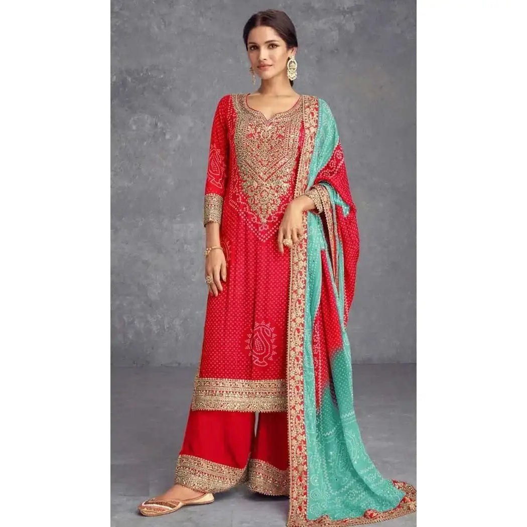 Red printed salwar suit with gold mirror work, flared pants and turquoise dupatta