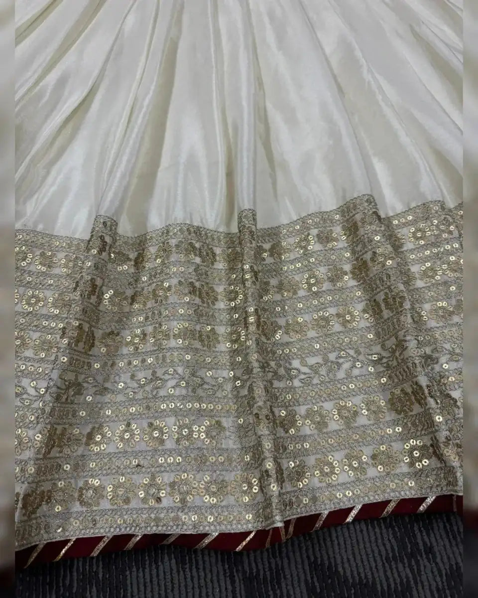 Ivory anarkali skirt with gold sequin band across tiers and subtle sparkle pattern