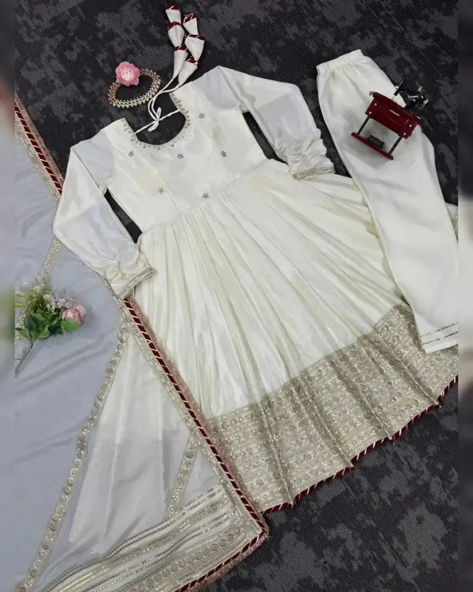 Ivory anarkali suit set flat lay with gold-trimmed dupatta and long kurta top
