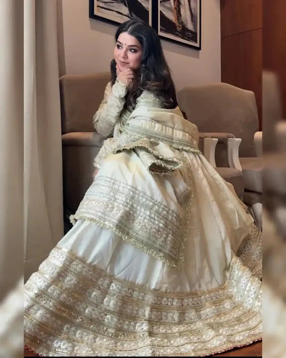 Ivory anarkali suit with wide gold embroidered bands and flared tiered skirt
