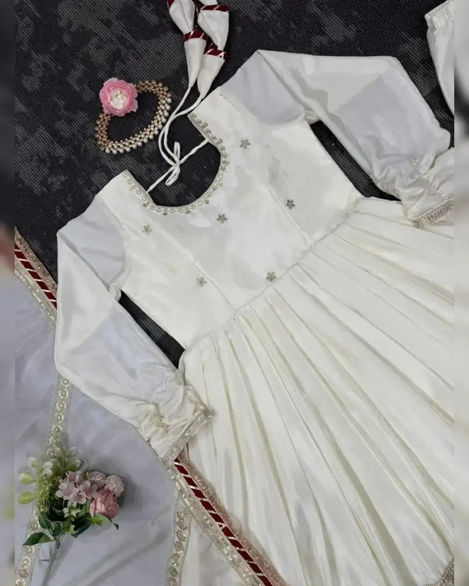 Ivory kurta with gold beadwork neckline, pleated skirt, and matching sleeve detailing