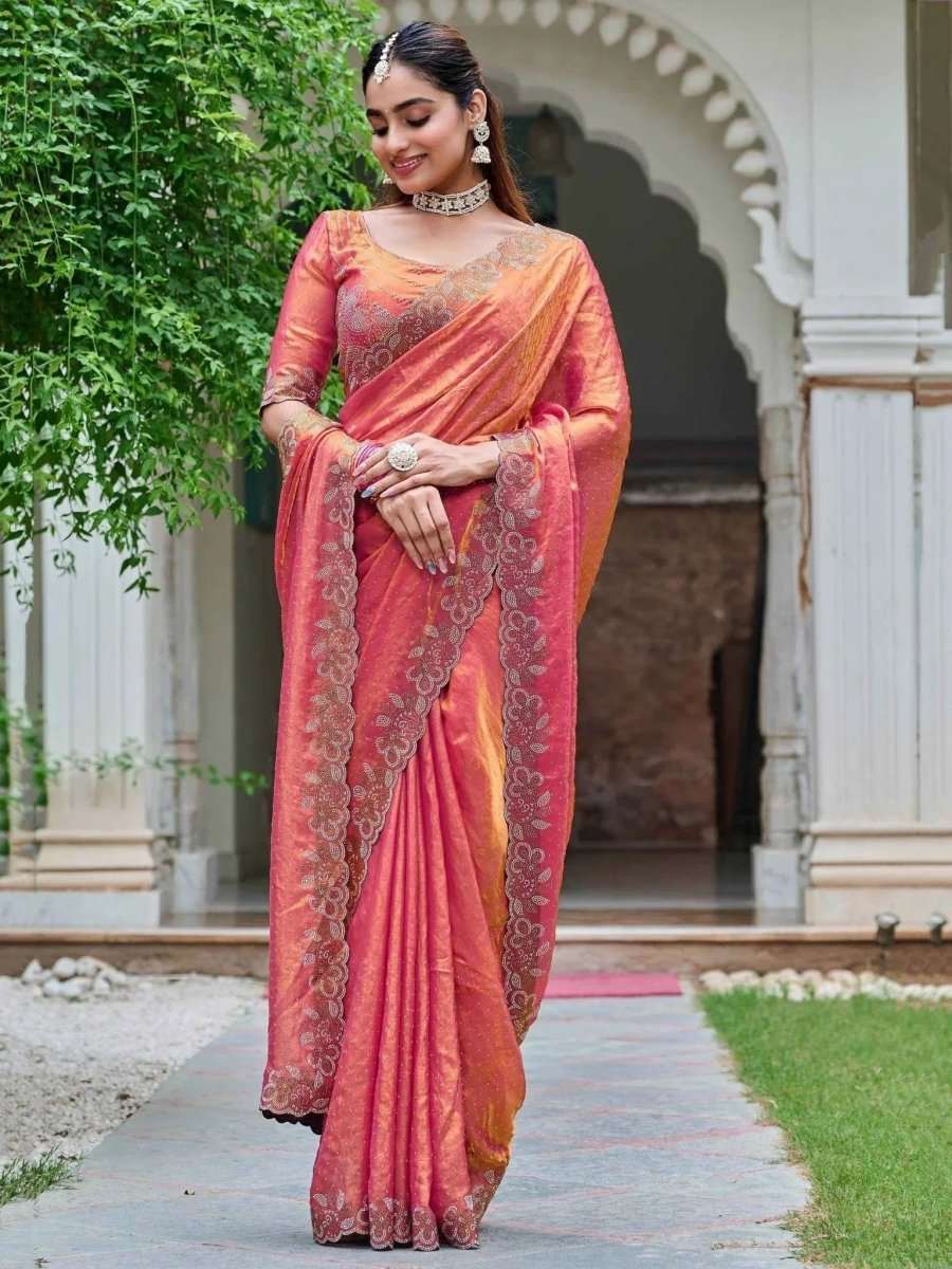 Coral rose silk saree featuring diamond work along the pallu and wide decorative border
