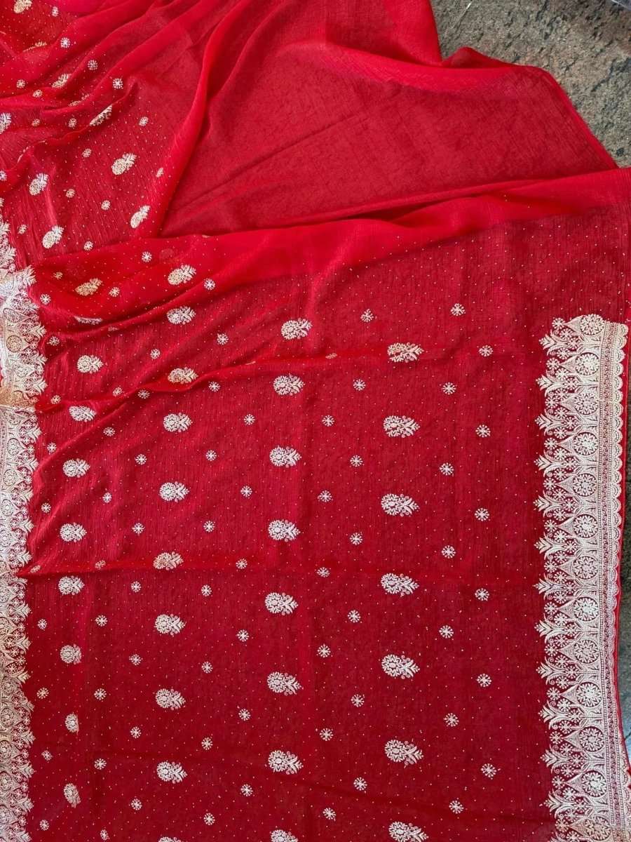 Embroidered festive saree with crimson red drape, silver dot pattern and ornate edge