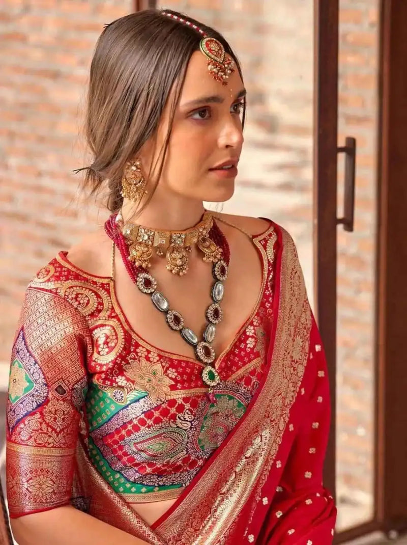 Crimson red silk saree with silver-cream embroidered center and multicolor motif accents