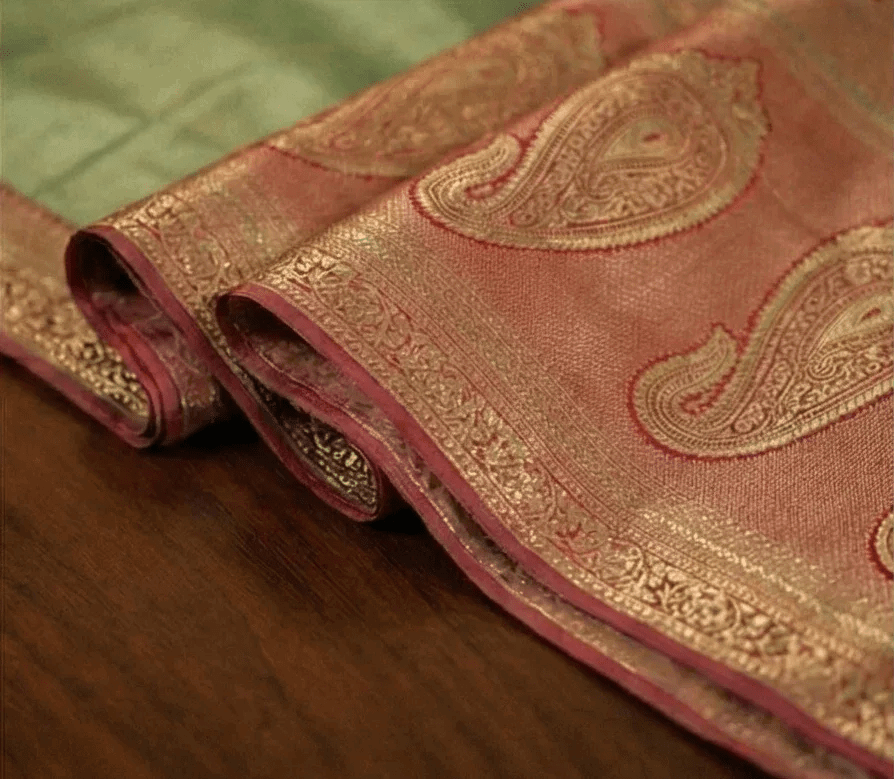 Paisley zari border on dual tone saree, rust-pink fabric with gold accents