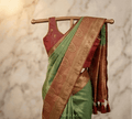 Dual tone silk saree, green body with rust-gold zari border and paisley pallu
