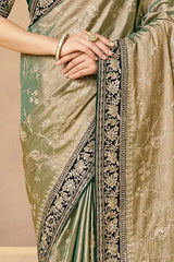 Gold saree body with dark green pleats and ornate embroidered border strip