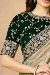 Green saree blouse with silver-toned embroidery and floral vine pattern, zari border