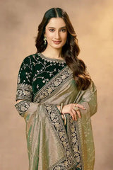 Emerald green and gold saree with embroidered pallu border and floral motif