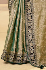 Gold and green saree with embroidered hem border and pleated drape