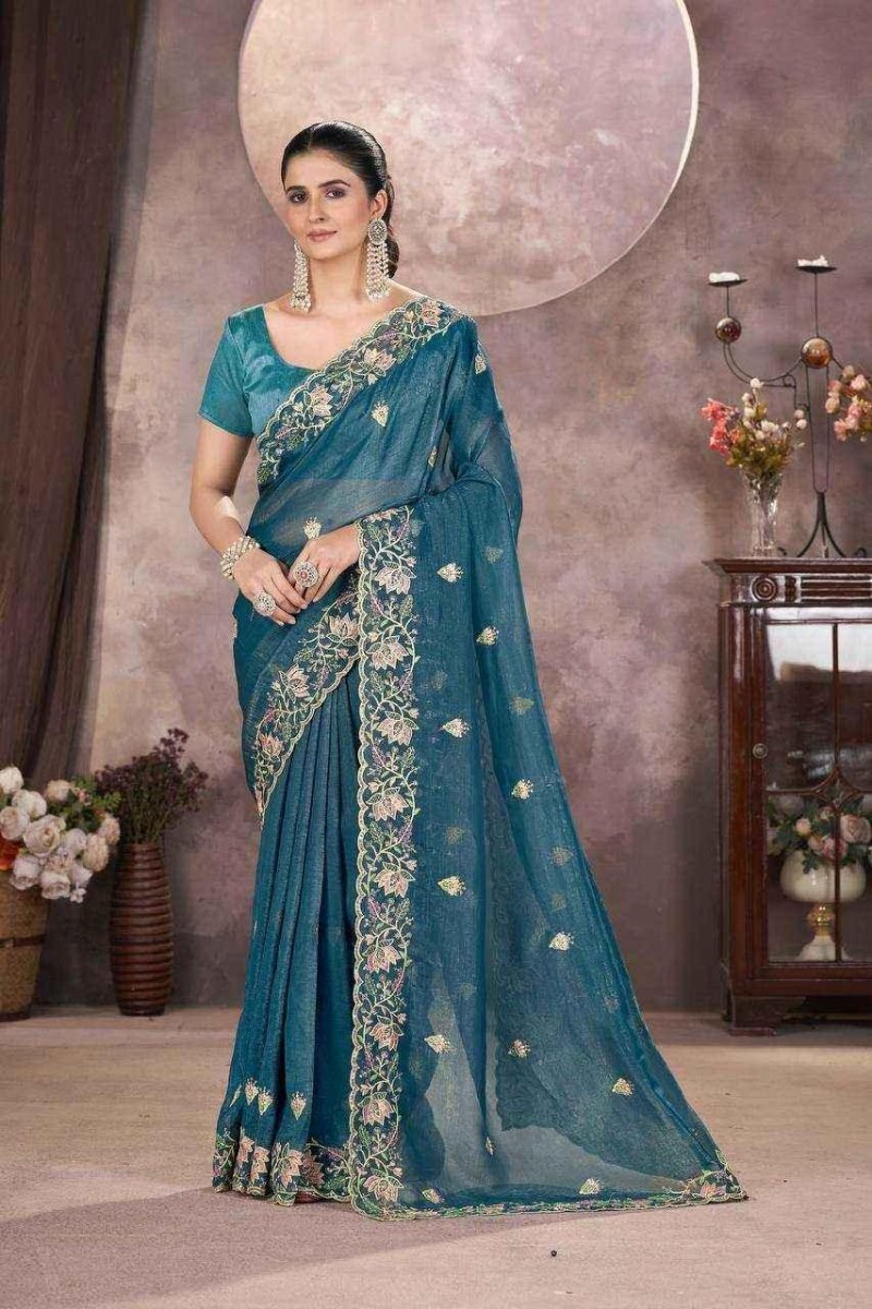 Teal embroidered saree with ornate border, full-length drape and blouse.