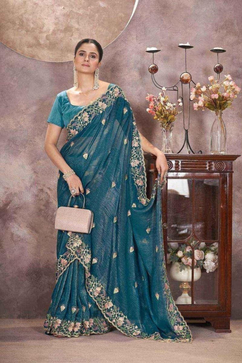 Teal embroidered saree with gold-trim border, side drape and matching blouse.