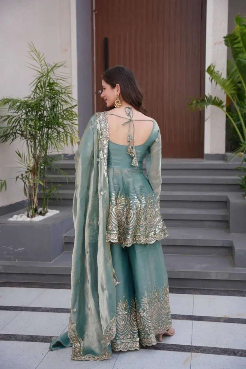 Teal satin sharara suit back view with gold mirror embroidery and long flowing dupatta