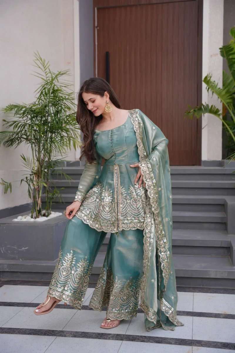 Teal satin sharara suit with gold mirror embroidery, peplum-style kurta and wide-leg pants