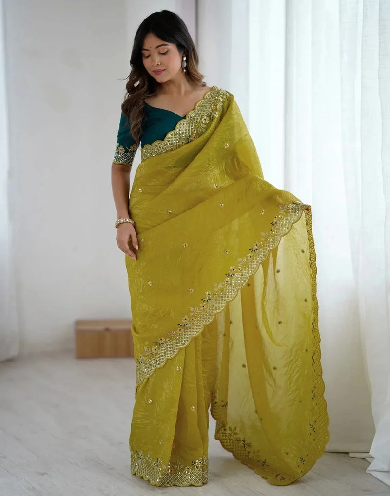 Yellow satin saree with gold border and shimmering sequin work