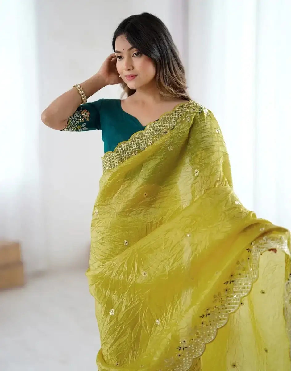 Yellow satin saree with gold embroidery on pallu and scalloped edge border