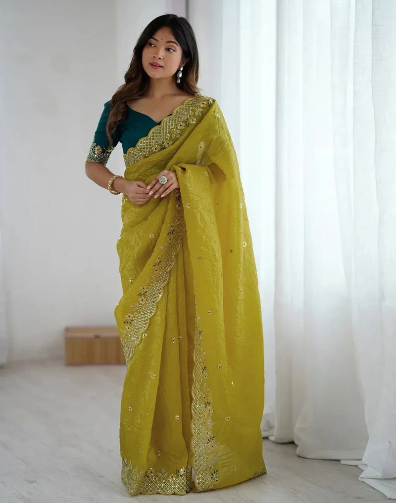 Yellow satin saree with gold embroidered border and sequined details
