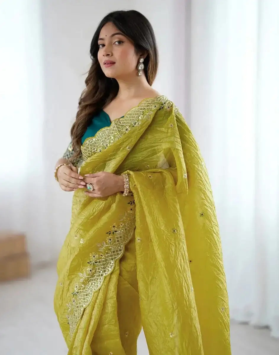 Yellow satin saree with gold embroidered border and dotted sequin motifs