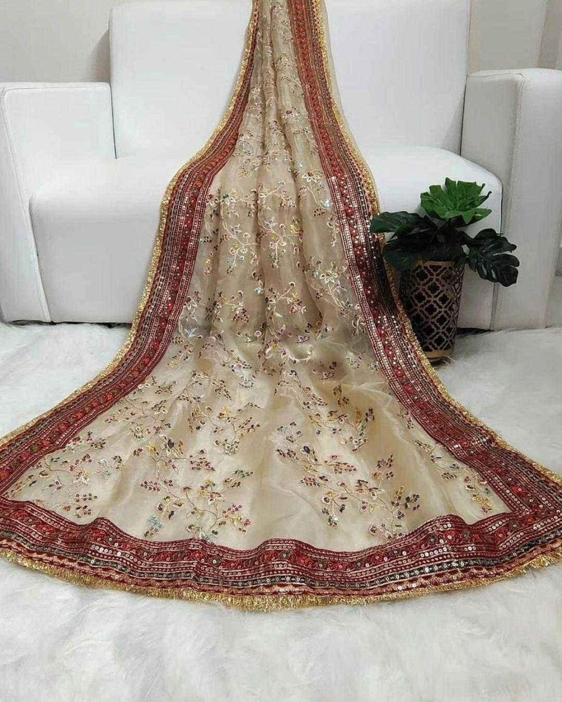Cream organza saree with maroon-red border and gold trim, scattered multicolor embroidery