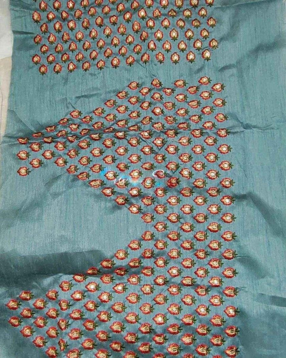 Embroidered organza saree with multicolor circular floral motifs on a blue base