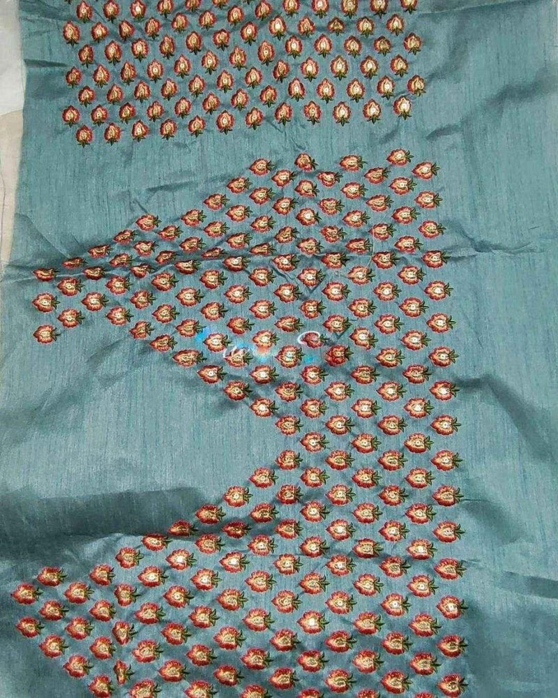 Embroidered organza saree with multicolor circular floral motifs on a blue base
