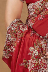 Red saree pleats and sleeve with gold-and-white floral embroidery, scalloped lace trim