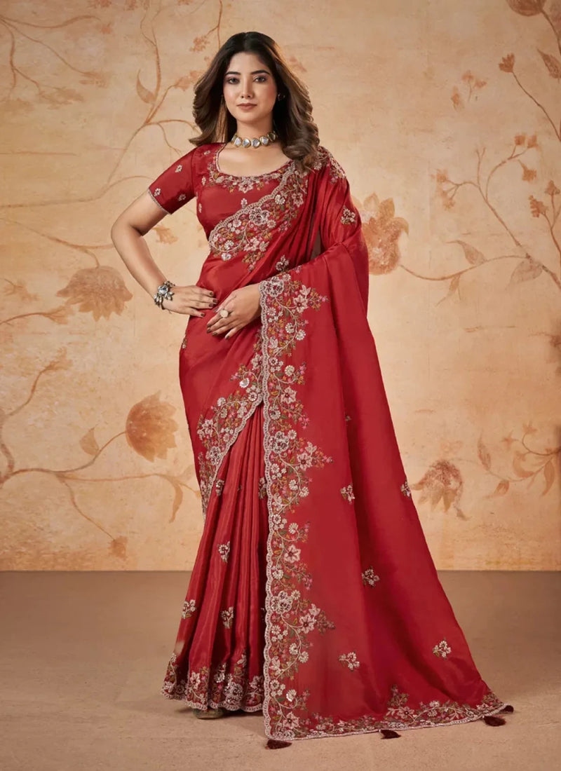 Red silk-style wedding saree with embroidered pallu and ornate floral border trim