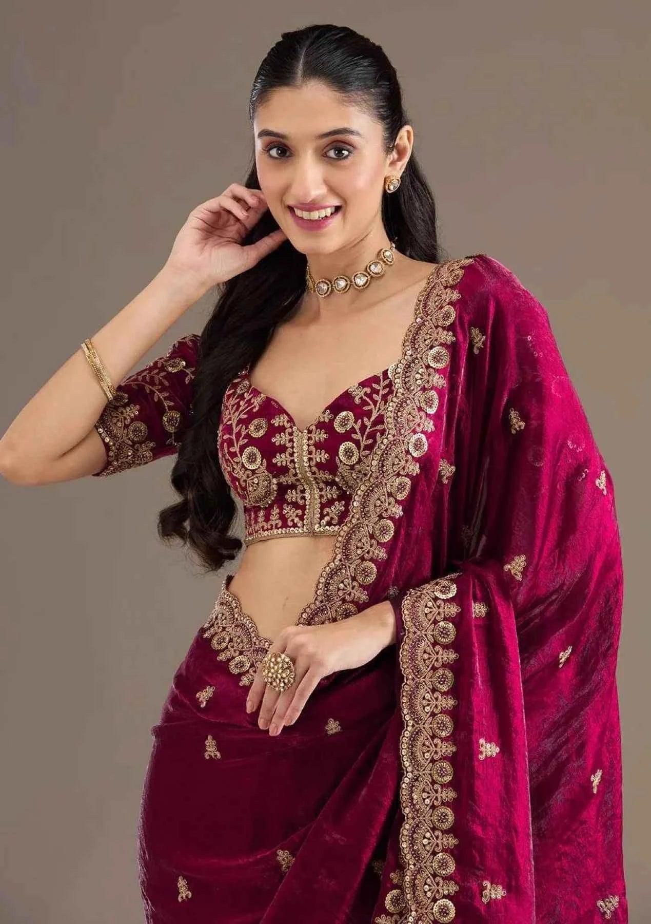 Woman wearing hot pink satin silk saree with heavy jari cutwork embroidery and matching blouse