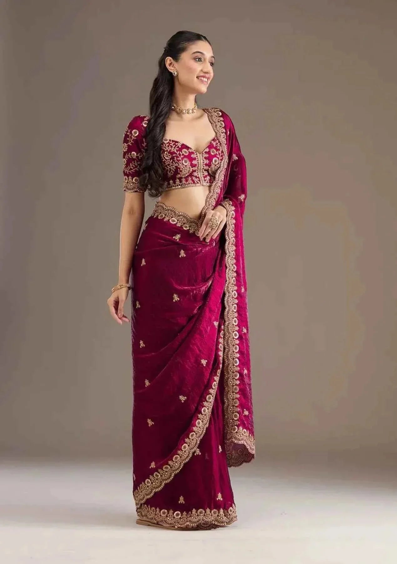 Woman wearing hot pink satin silk saree with heavy jari cutwork embroidery and matching blouse