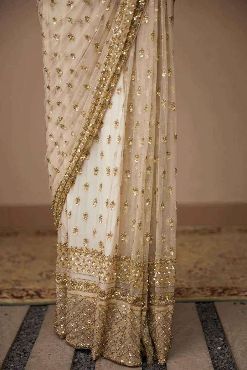 Ivory net saree hem with gold sequin border and embellished drape
