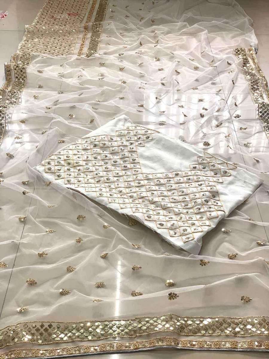 Ivory net saree fabric with gold sequin motifs and border trim, folded