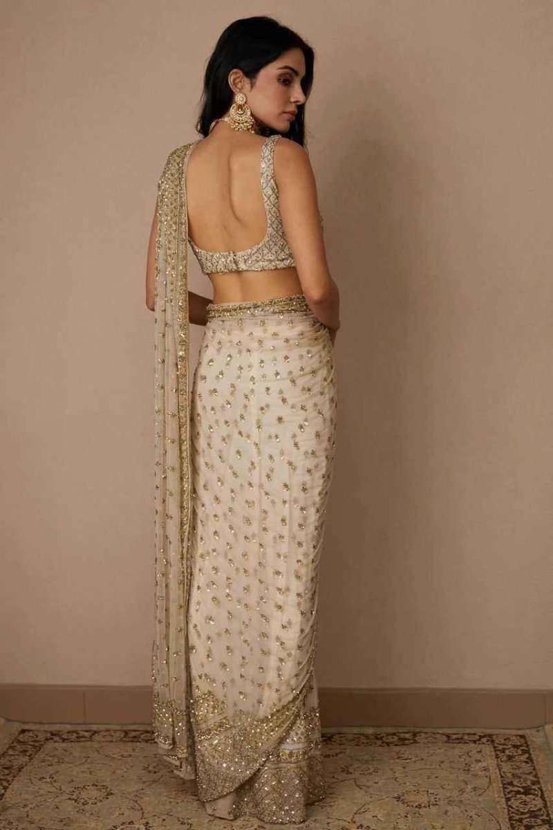 Ivory and gold sequin net saree with open-back blouse and draped pallu, seen from back