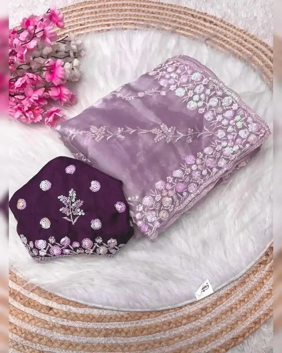 Lavender satin saree with floral sequin border and lilac pallu, plus dark purple blouse