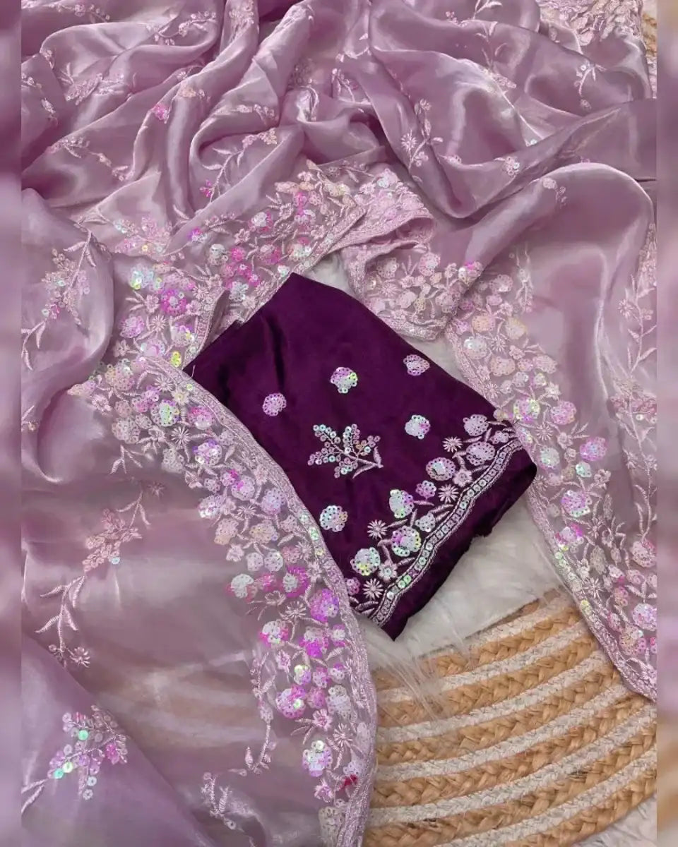 Lavender satin saree with floral sequin motifs, golden striped border, and dark purple blouse