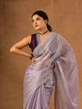 Lavender soft saree with zari and sequin embroidery border, draped over one shoulder