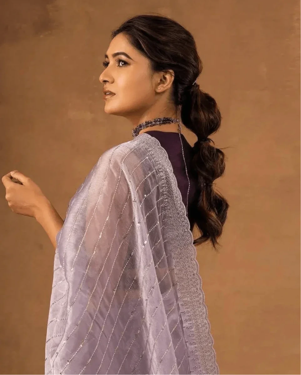 Lavender saree with dotted sequin design and zari stripes, side view