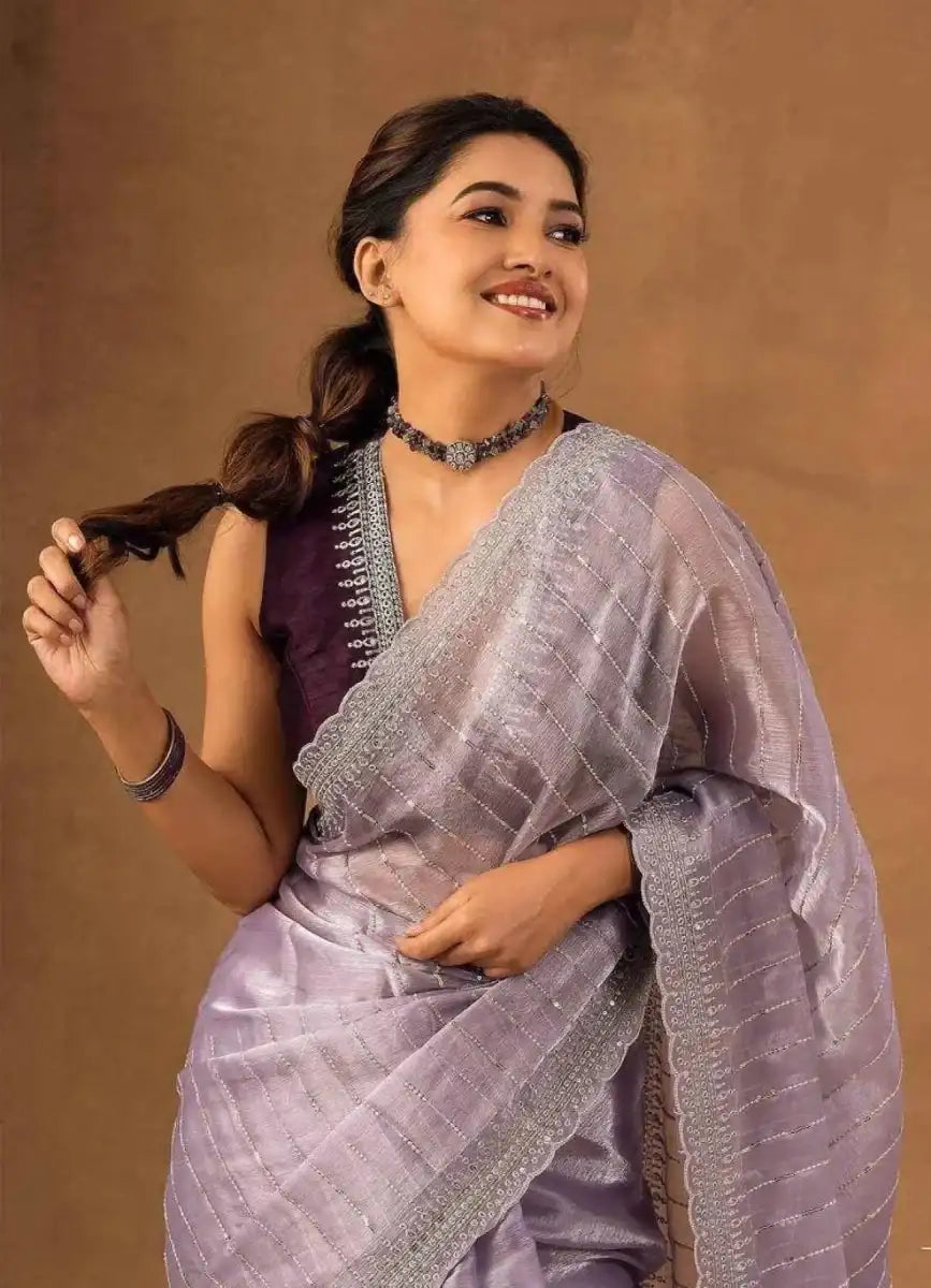 Lavender saree with sequin and zari embroidery border, tied pleats and pallu drape