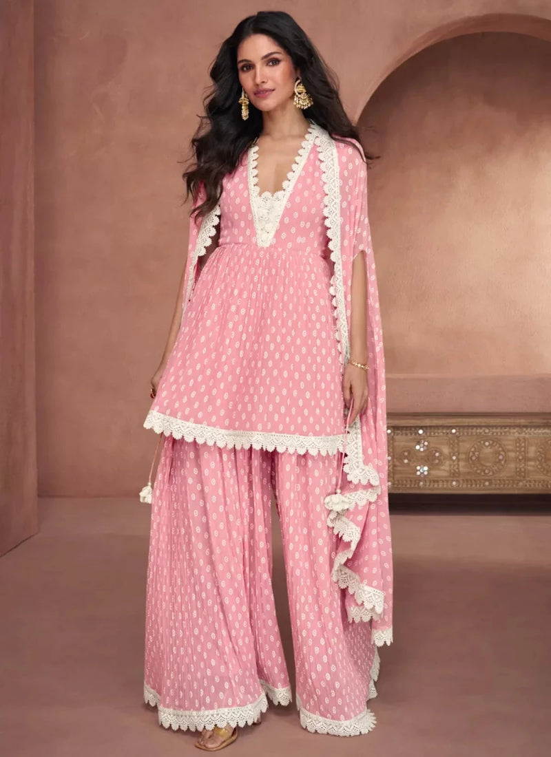 Baby pink printed peplum top with lace trim, wide-leg palazzo, and lace-bordered dupatta