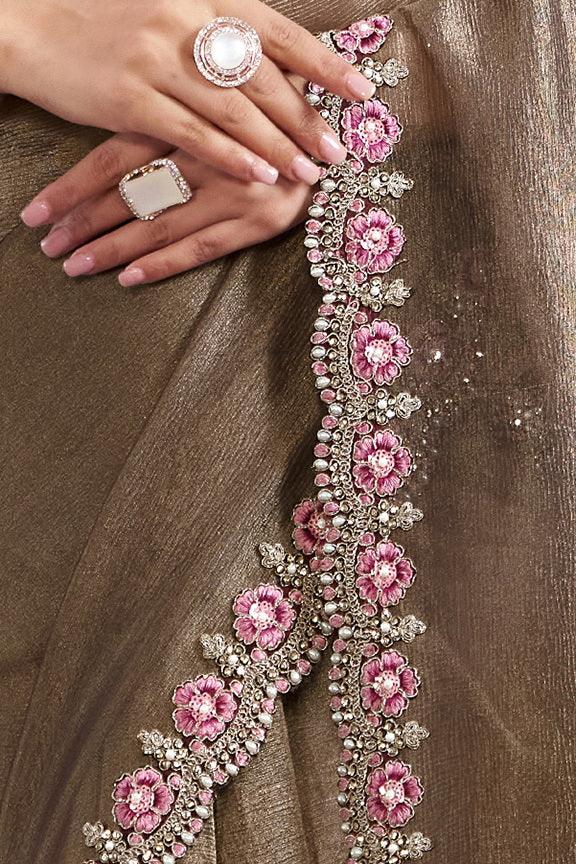 Bronze saree drape with pink and silver floral border embellishment
