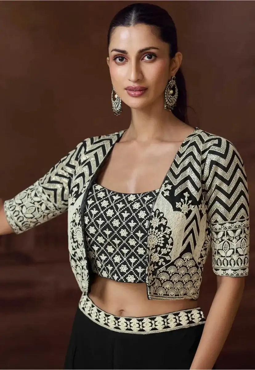Cropped jacket with zigzag cuffs and medallion over black co-ord skirt
