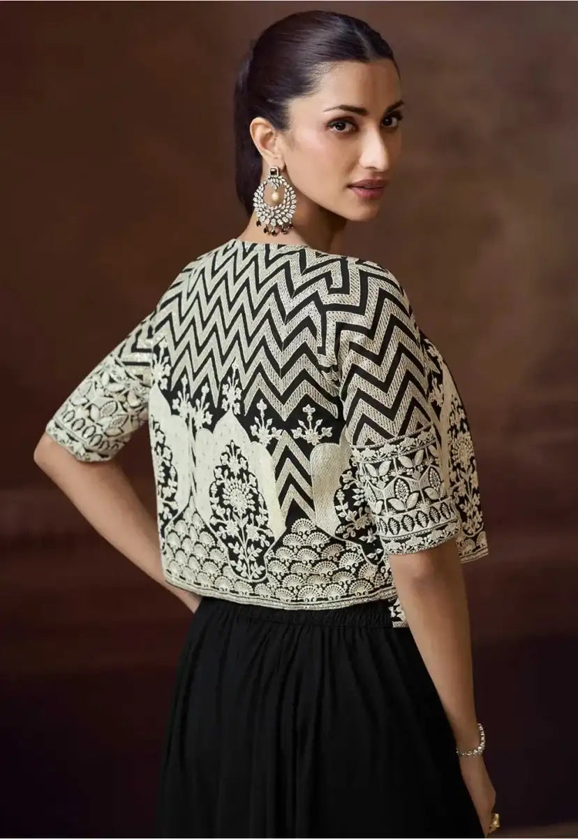 Back view of cropped black-and-copper zigzag jacket with ornate hem motifs