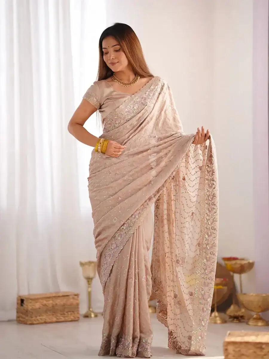 Champagne beige saree with glittering sequin pattern and wide lace-like border
