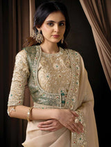Embroidered champagne blouse with emerald accents, round neckline, and long sleeves