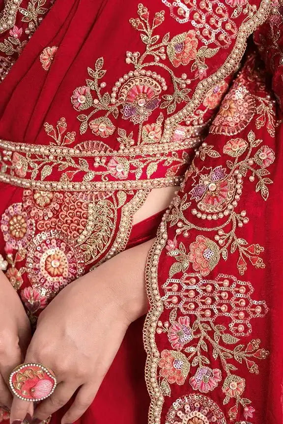 Cherry red saree close-up of gold embroidered belt and floral motif sleeve