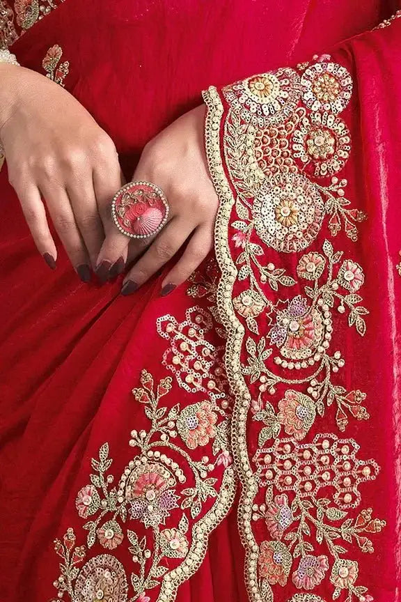 Cherry red saree fabric detail with dense gold zari floral embroidery