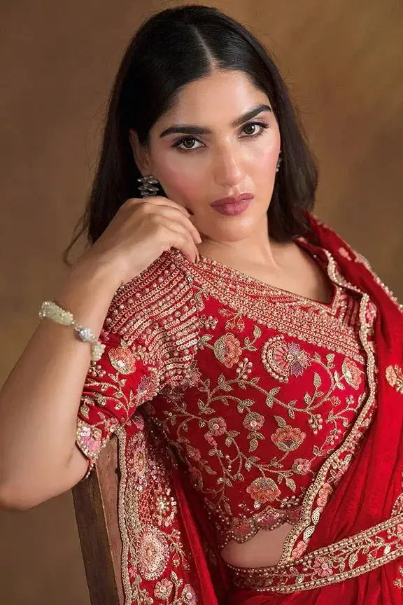 Cherry red saree blouse with ornate gold embroidery and draped matching pallu