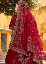Maroon velvet lehenga back with heavy embroidered border and draped dupatta veil